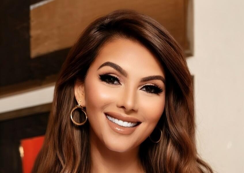 Somy Ali smiling, wearing a “Human Being” T-shirt – representing empathy and awareness.